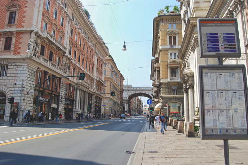 30 - Via XX Settembre in Genoa, Italy, featuring its signature grand nineteenth-century architecture, elegant arcades, and the iconic Ponte Monumentale arching across the street